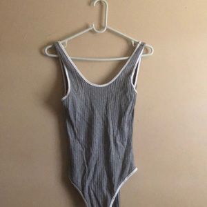 a light gray bodysuit